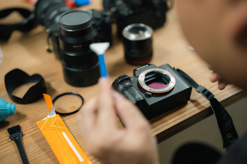 cleaning a mirrorless camera on a wooden table 2026 01 09 07 12 06 utc