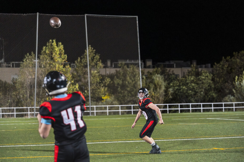 football players throwing the ball on green field 2026 01 09 12 13 44 utc