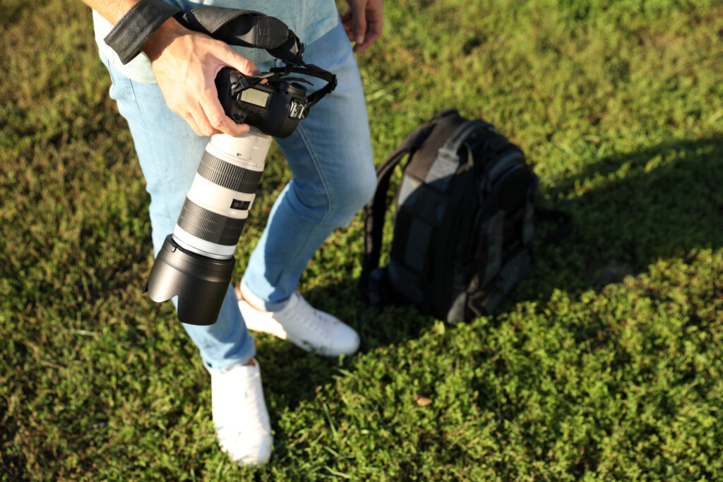 photographer holds camera in sunny field 2026 03 05 11 49 37 utc